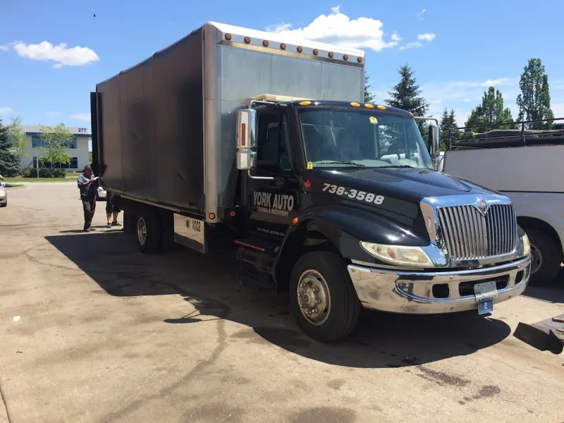 A York Auto heavy tow truck towing a box truck